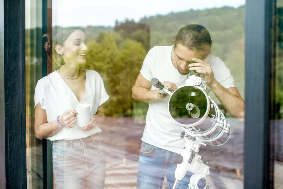 Couple avec un télescope à la maison